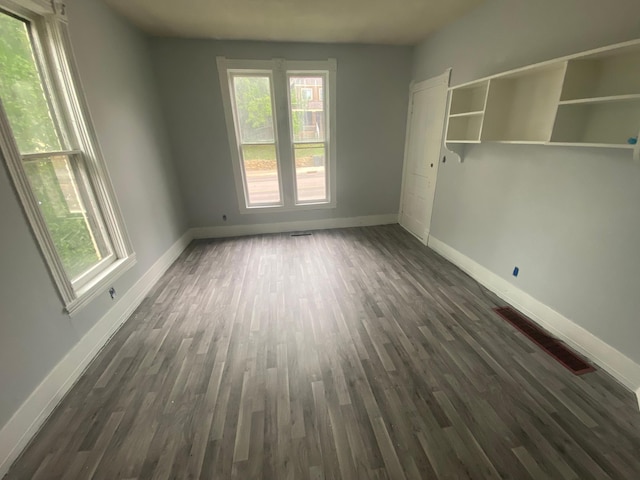 unfurnished room featuring dark hardwood / wood-style floors