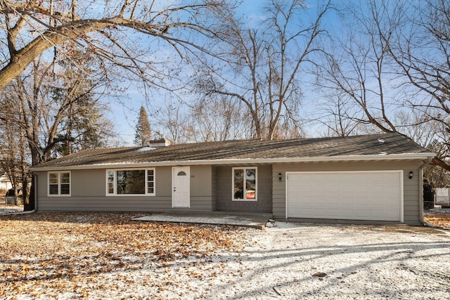 ranch-style home with a garage, driveway, and a chimney