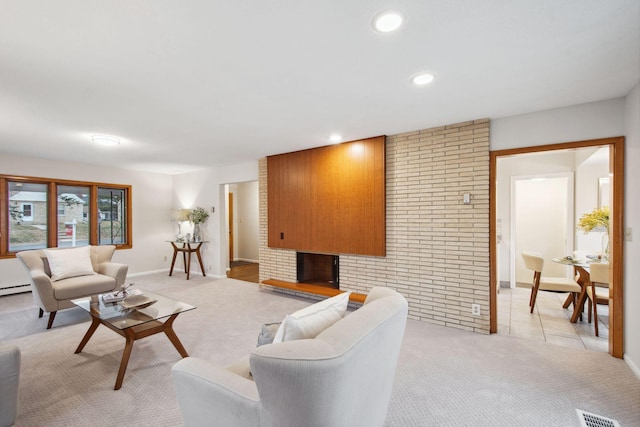 living room featuring a fireplace, recessed lighting, light colored carpet, visible vents, and brick wall