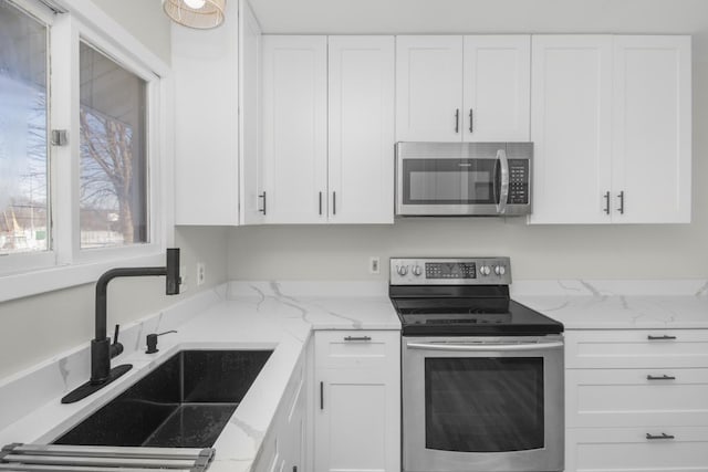 kitchen featuring white cabinetry, stainless steel appliances, and sink