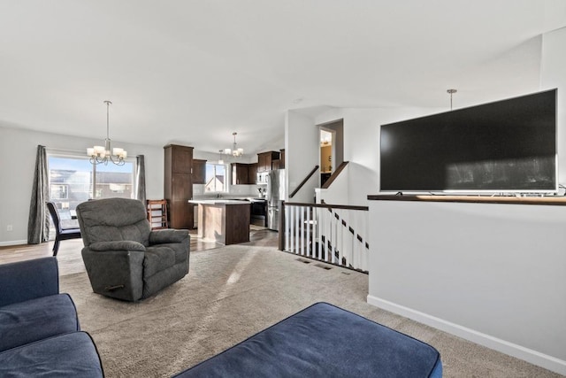 living room featuring lofted ceiling, light colored carpet, and an inviting chandelier