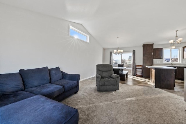 living room with carpet floors, a chandelier, and a healthy amount of sunlight