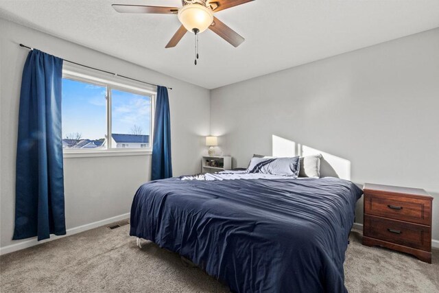 bedroom with ceiling fan and light colored carpet