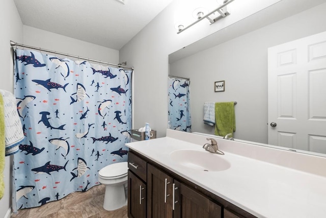 bathroom featuring toilet, vanity, and a shower with shower curtain