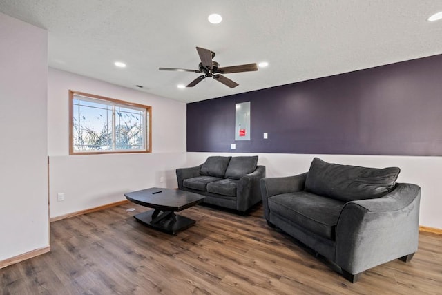 living room with hardwood / wood-style floors and ceiling fan