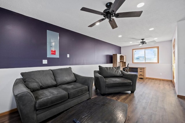 living room with hardwood / wood-style floors and electric panel