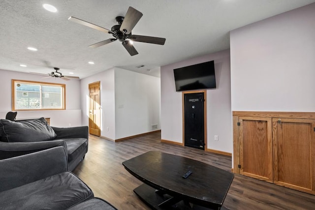 living room featuring dark hardwood / wood-style flooring and a textured ceiling