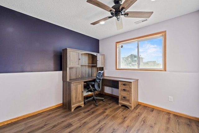 office with ceiling fan, dark hardwood / wood-style floors, and a textured ceiling