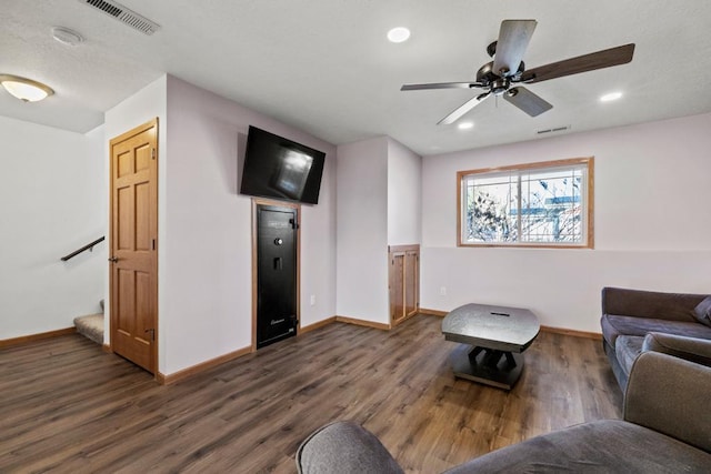 living room with ceiling fan and dark hardwood / wood-style floors