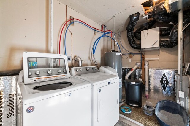 clothes washing area with washer and dryer and water heater