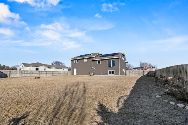 back of house with solar panels