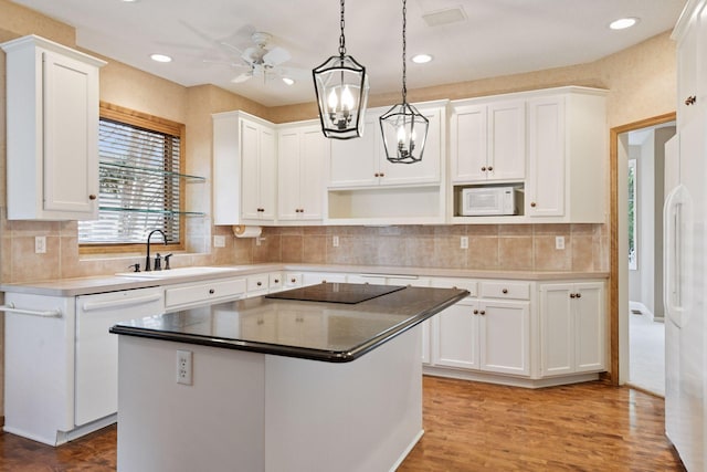kitchen featuring white cabinetry, a sink, and white appliances