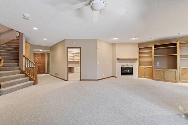 unfurnished living room with recessed lighting, stairway, light colored carpet, and baseboards