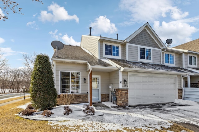 view of front of home with stone siding and an attached garage