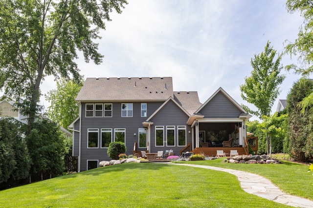 221 George St, Excelsior, MN 55331 - rear view of house with a lawn, roof with shingles, and a sunroom