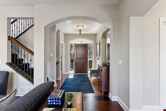 221 George St, Excelsior, MN 55331 - entryway with wood finished floors, arched walkways, baseboards, and stairs