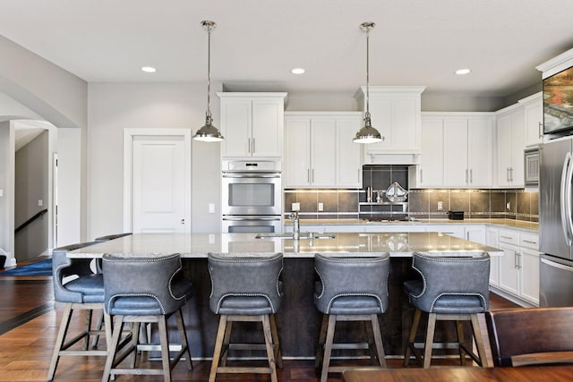 221 George St, Excelsior, MN 55331 - kitchen with appliances with stainless steel finishes, a sink, white cabinets, and recessed lighting
