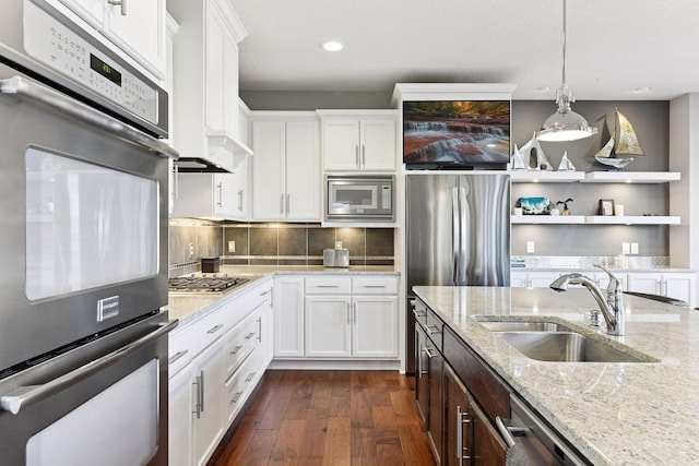 221 George St, Excelsior, MN 55331 - kitchen with stainless steel appliances, a sink, white cabinets, dark wood finished floors, and recessed lighting