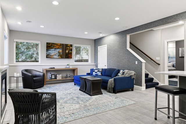 221 George St, Excelsior, MN 55331 - living room featuring stairway, recessed lighting, baseboards, light wood finished floors, and an accent wall