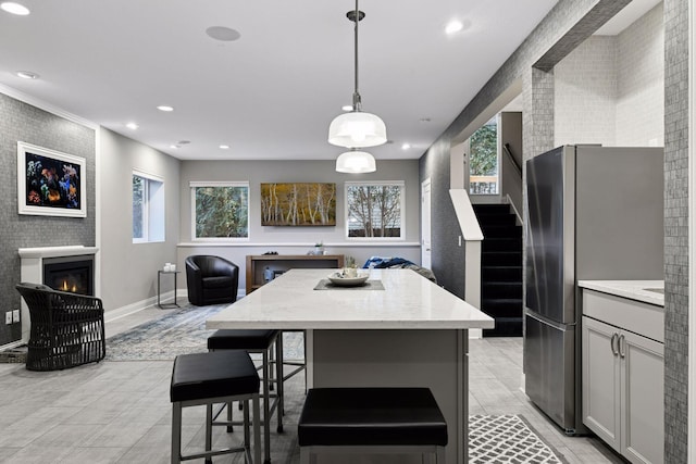 221 George St, Excelsior, MN 55331 - kitchen featuring freestanding refrigerator, open floor plan, recessed lighting, a center island, and plenty of natural light