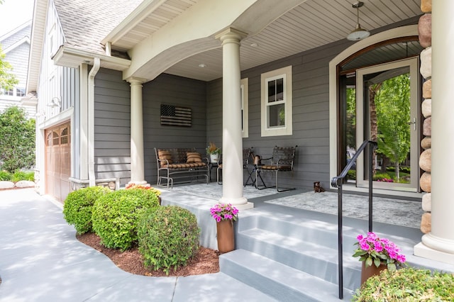 221 George St, Excelsior, MN 55331 - view of exterior entry with a porch, an attached garage, and a shingled roof