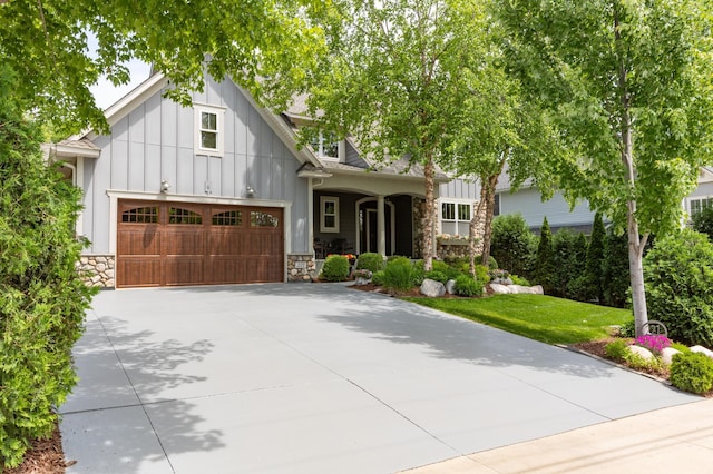221 George St, Excelsior, MN 55331 - view of front of property with board and batten siding, stone siding, and concrete driveway
