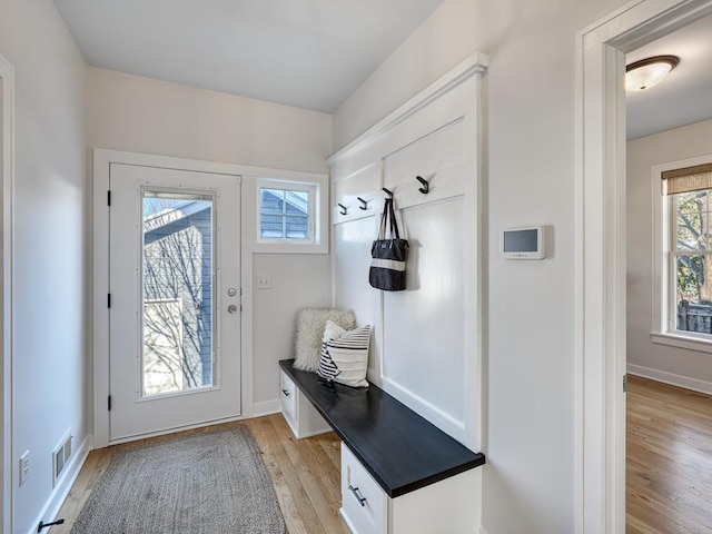 mudroom with light wood-style floors, visible vents, and baseboards