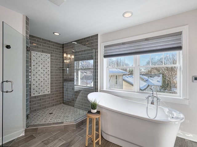 bathroom with a freestanding tub, recessed lighting, a wealth of natural light, and a stall shower