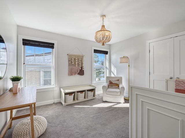 sitting room with baseboards and carpet flooring