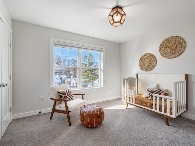 sitting room featuring carpet and baseboards