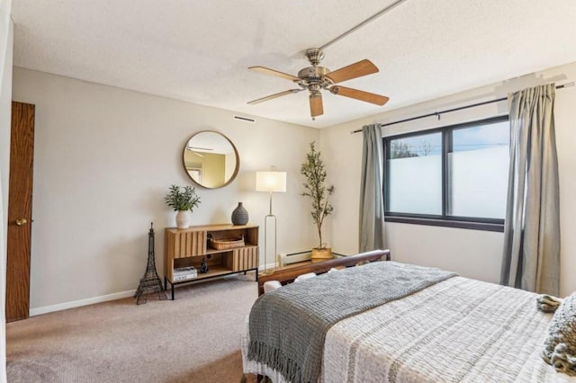 bedroom with ceiling fan, a textured ceiling, a baseboard heating unit, baseboards, and carpet