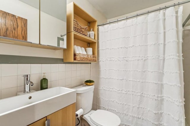 full bath featuring vanity, toilet, and tile walls