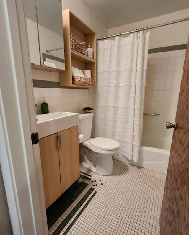 full bath featuring toilet, tile walls, vanity, tile patterned floors, and shower / bathtub combination with curtain