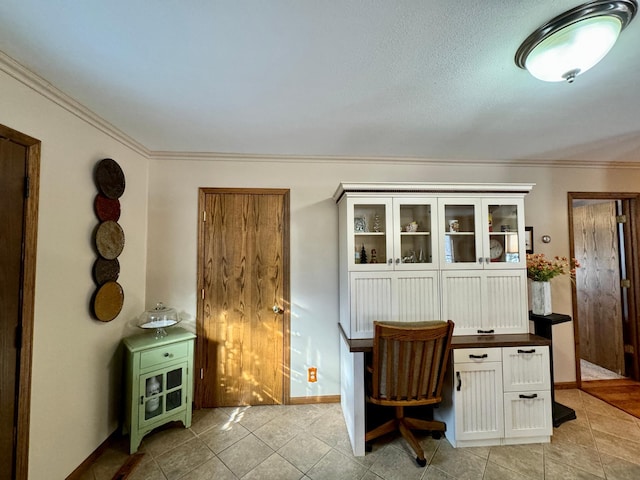 home office featuring ornamental molding, light tile patterned flooring, and baseboards