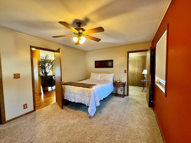 bedroom with light carpet, ceiling fan, ornamental molding, and baseboards