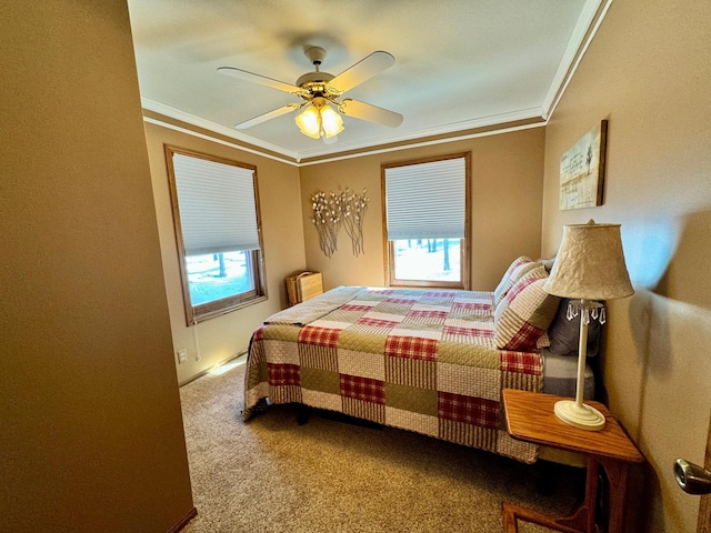 carpeted bedroom featuring ornamental molding and ceiling fan