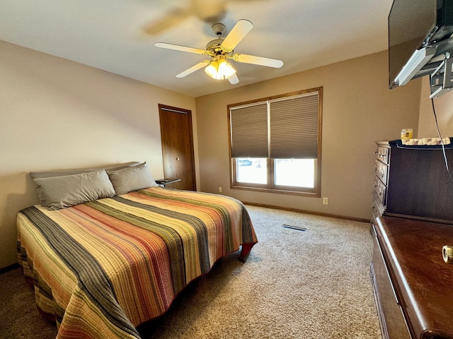 bedroom with a ceiling fan, visible vents, baseboards, and carpet flooring