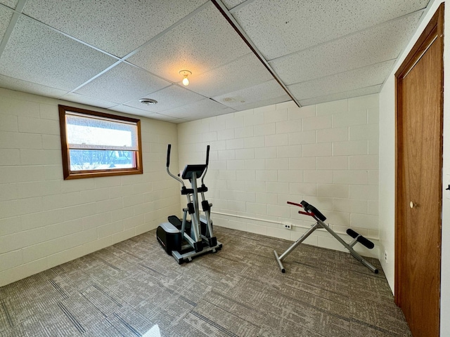 workout room featuring carpet flooring, visible vents, and concrete block wall