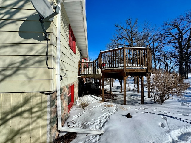 snow covered property with a deck