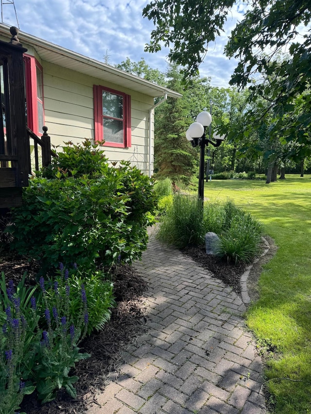 view of side of home with a yard