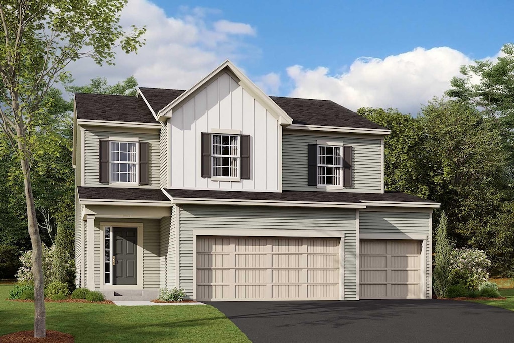 view of front of home with a garage, driveway, a front lawn, and board and batten siding