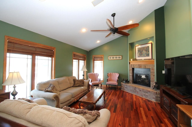 living room with dark hardwood / wood-style flooring, ceiling fan, high vaulted ceiling, and a brick fireplace