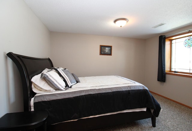 carpeted bedroom with a textured ceiling