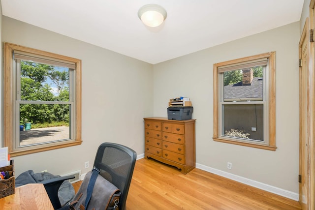 office space featuring light wood-style flooring and baseboards