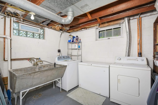 laundry area featuring laundry area, washer and clothes dryer, and a sink