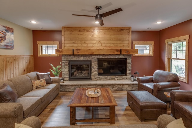 living room with a fireplace, wood finished floors, and a healthy amount of sunlight