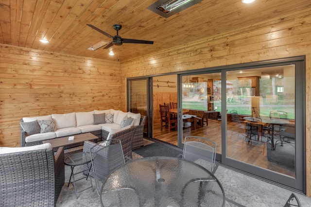 living room with a ceiling fan, wooden ceiling, and wooden walls