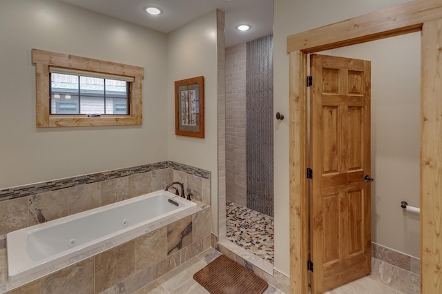 bathroom featuring a jetted tub, a shower stall, and recessed lighting