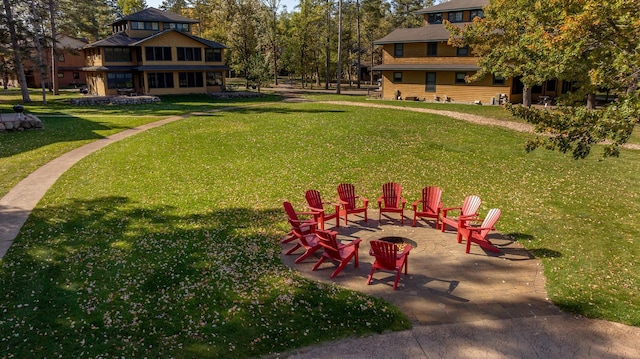 view of yard with a patio and an outdoor fire pit