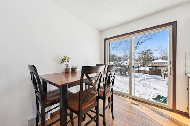 dining space featuring visible vents and light wood-style floors